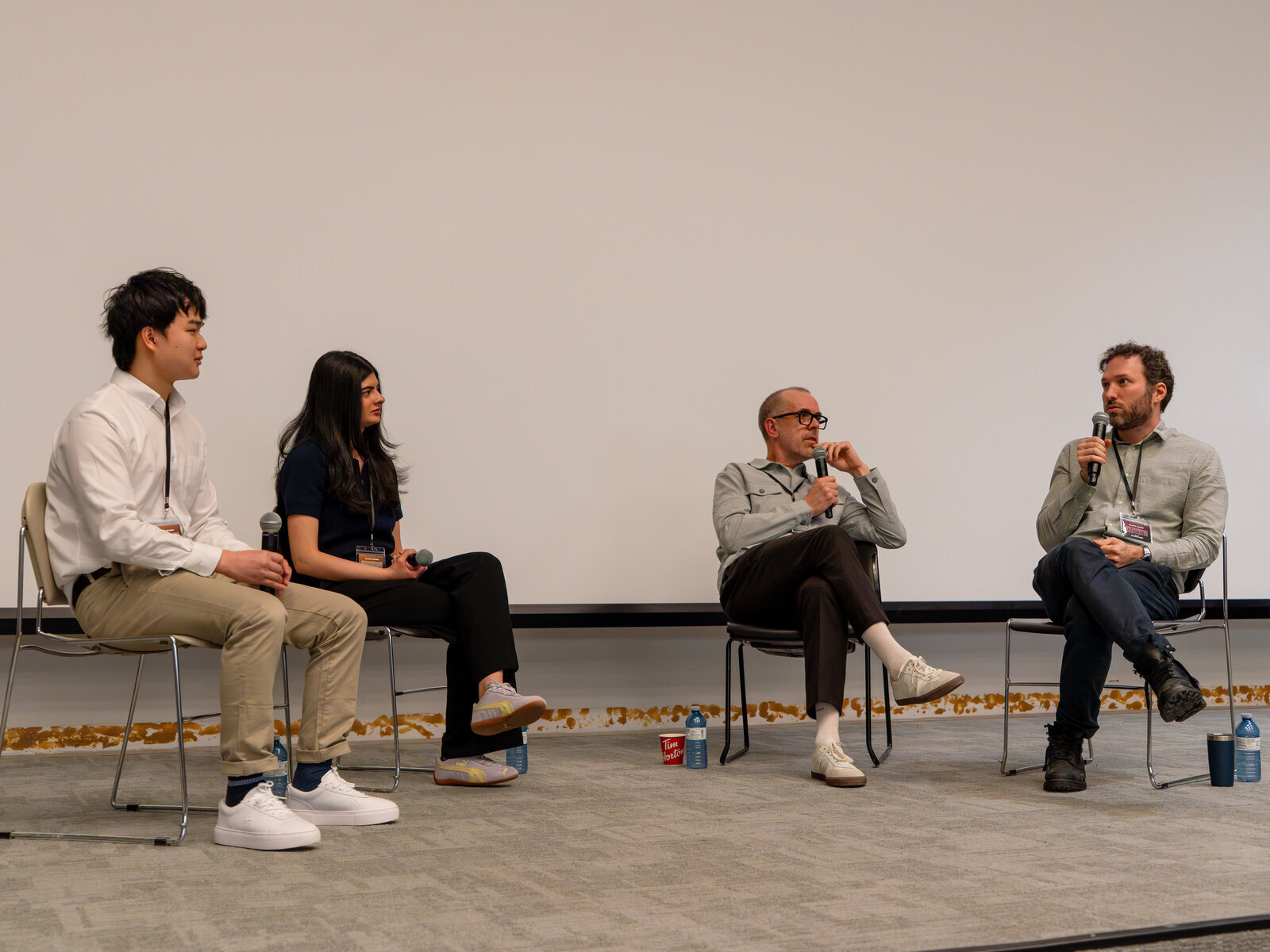 Four panelists seated on stage during the SAIL@UofT AI Q&A event.